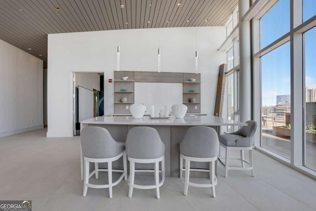 kitchen with open shelves, a center island, wood ceiling, and expansive windows