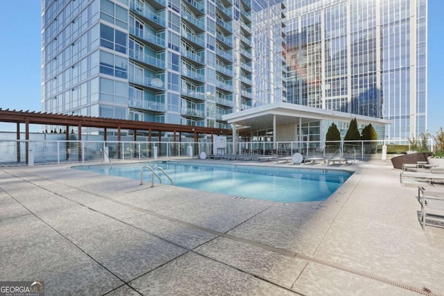 pool featuring a patio area and fence