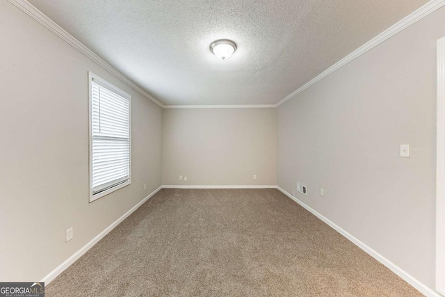 carpeted spare room with a textured ceiling, visible vents, baseboards, and ornamental molding