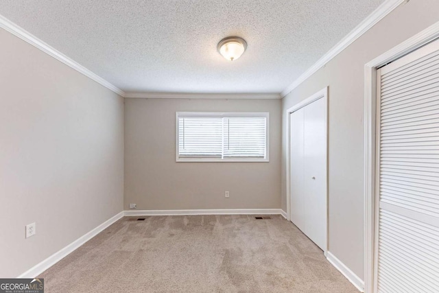 unfurnished bedroom with baseboards, light colored carpet, and ornamental molding