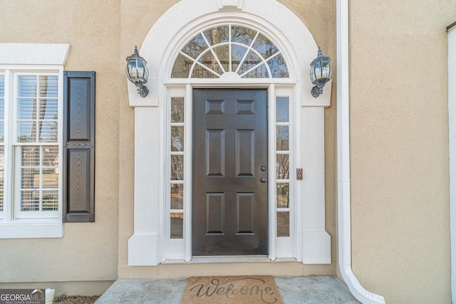 property entrance featuring stucco siding