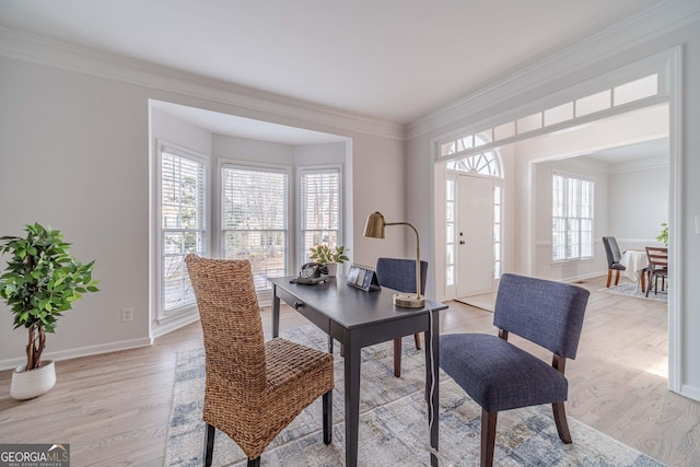 office with crown molding and light wood finished floors