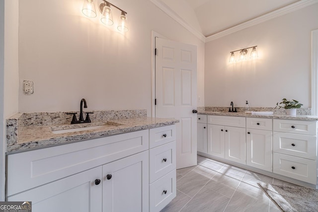 full bath featuring a sink, two vanities, crown molding, and vaulted ceiling