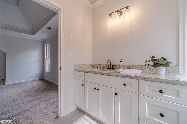 bathroom featuring visible vents, vanity, baseboards, and ornamental molding