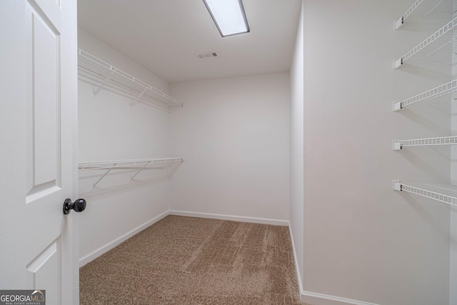 spacious closet with carpet and visible vents