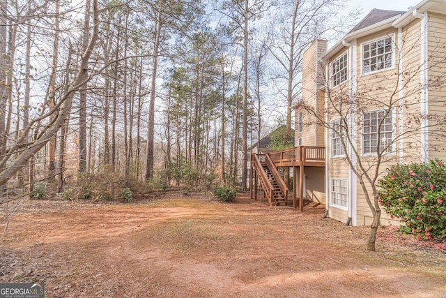 view of yard featuring stairs and a wooden deck