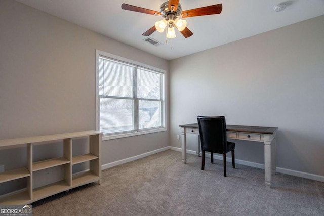 carpeted home office featuring baseboards, visible vents, and ceiling fan