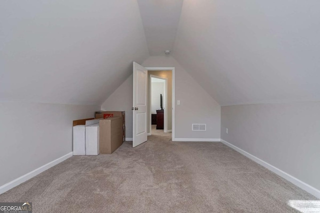 bonus room with carpet, lofted ceiling, baseboards, and visible vents