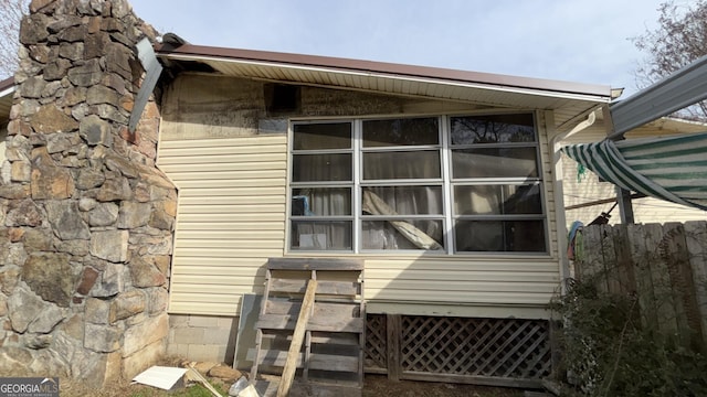 view of side of home featuring fence