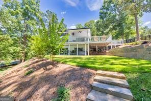 6505 Samoa Way, Flowery Branch, GA 30542 - rear view of house with a wooden deck and a lawn