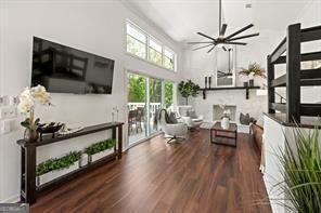 living room featuring a ceiling fan and wood finished floors