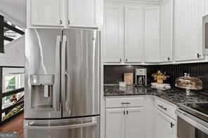 6505 Samoa Way, Flowery Branch, GA 30542 - kitchen with stainless steel appliances, white cabinets, and dark countertops