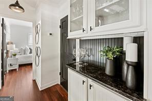 bar with dark wood-type flooring and baseboards