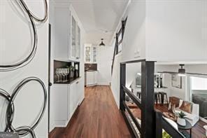 hallway featuring dark wood finished floors and stacked washer / drying machine