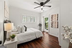 bedroom with ceiling fan, dark wood finished floors, and ornamental molding