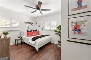 bedroom featuring a ceiling fan, wood finished floors, and baseboards