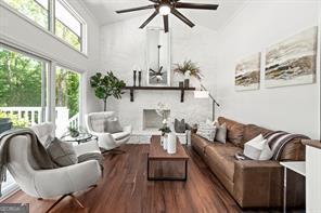 living room featuring ceiling fan and wood finished floors