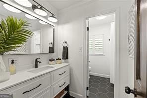 bathroom with vanity and baseboards