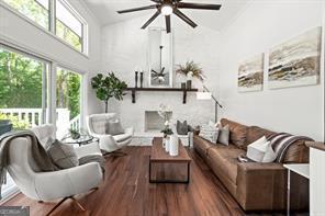 6505 Samoa Way, Flowery Branch, GA 30542 - living area with ceiling fan, wood finished floors, and a towering ceiling