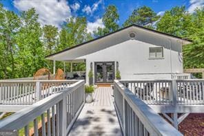 rear view of house featuring a deck