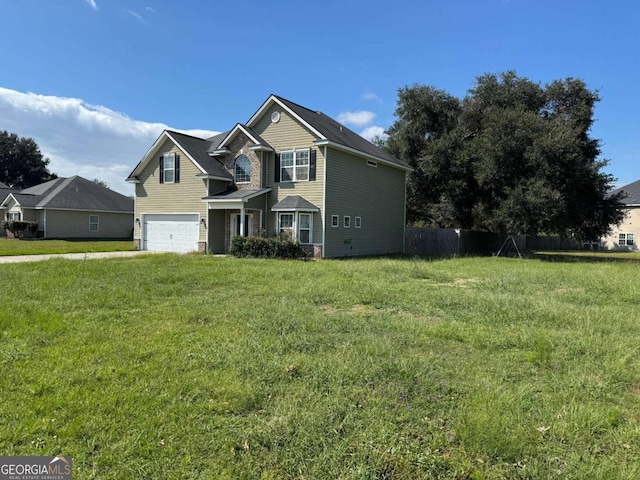 traditional-style home featuring a front lawn, an attached garage, and fence