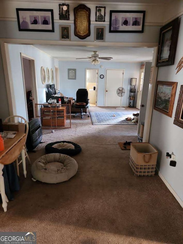 carpeted living room with baseboards and ceiling fan