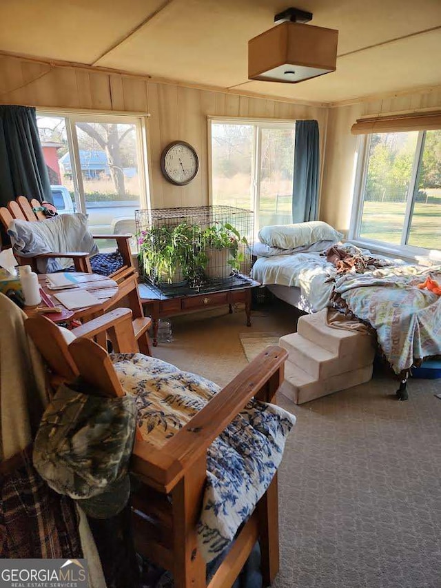 bedroom featuring carpet floors and wood walls