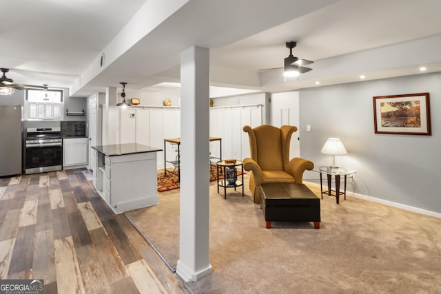 interior space featuring recessed lighting, baseboards, ceiling fan, and wood finished floors