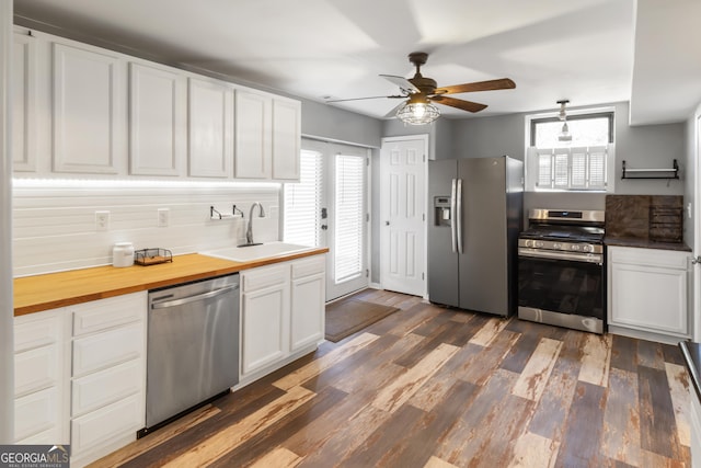 kitchen featuring dark wood-style floors, a healthy amount of sunlight, appliances with stainless steel finishes, and a sink