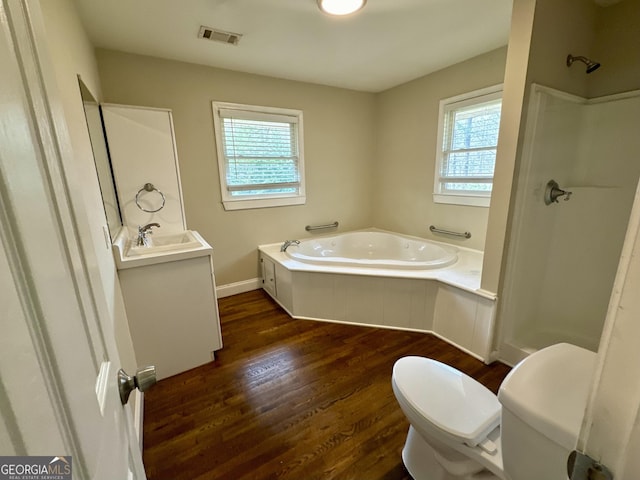 full bathroom featuring visible vents, toilet, a garden tub, wood finished floors, and a shower