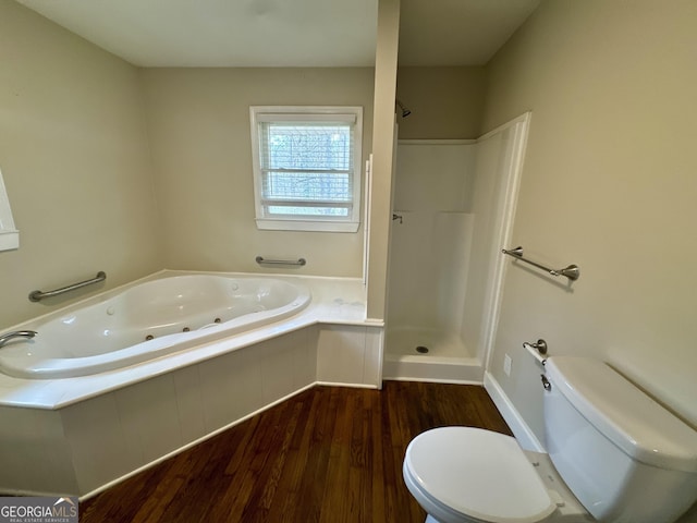 full bath featuring a jetted tub, toilet, a shower, and wood finished floors