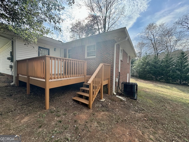 back of property with a wooden deck and brick siding