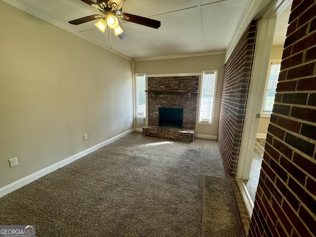 unfurnished living room featuring crown molding, a brick fireplace, carpet, and baseboards