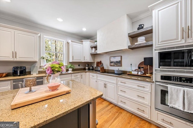 kitchen featuring white cabinetry, open shelves, appliances with stainless steel finishes, and ornamental molding