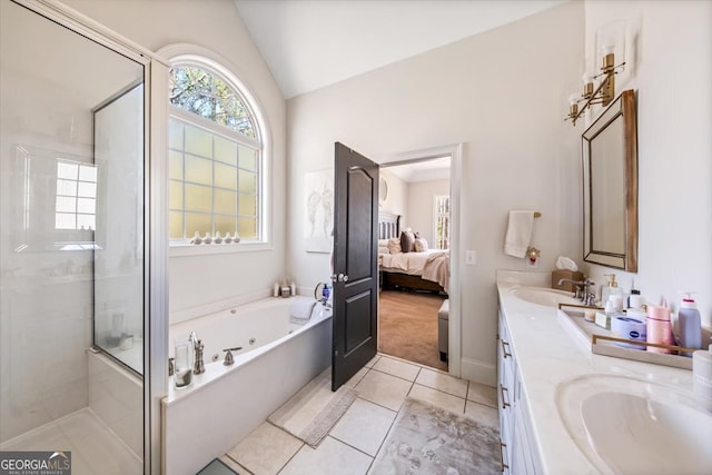 bathroom featuring lofted ceiling, a stall shower, a whirlpool tub, and a sink