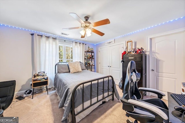 bedroom featuring ceiling fan, visible vents, a closet, and light carpet