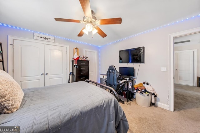 bedroom featuring multiple closets, carpet flooring, baseboards, and ceiling fan