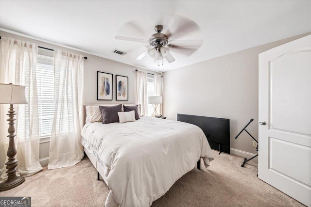 bedroom with baseboards, visible vents, carpet floors, and ceiling fan