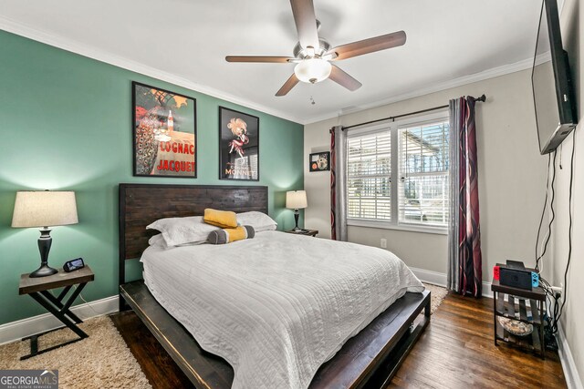 bedroom featuring crown molding, baseboards, and wood finished floors