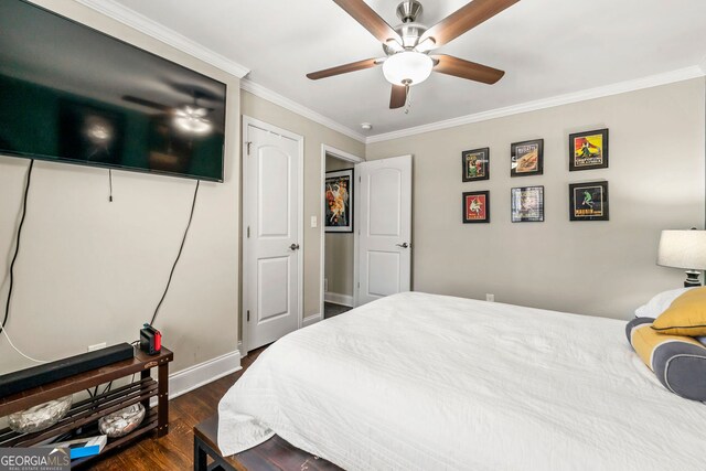 bedroom with baseboards, a ceiling fan, dark wood finished floors, and crown molding