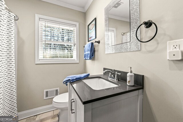 bathroom featuring visible vents, toilet, crown molding, and baseboards