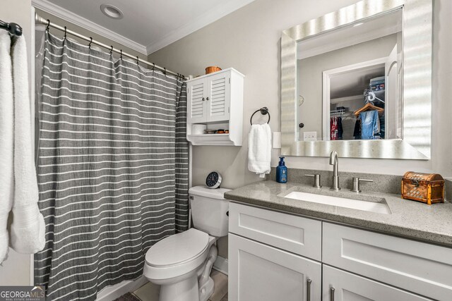 bathroom with toilet, curtained shower, vanity, and crown molding