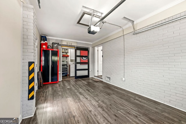 garage featuring visible vents, a garage door opener, and freestanding refrigerator