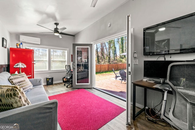 living room featuring lofted ceiling, an AC wall unit, wood finished floors, and a healthy amount of sunlight