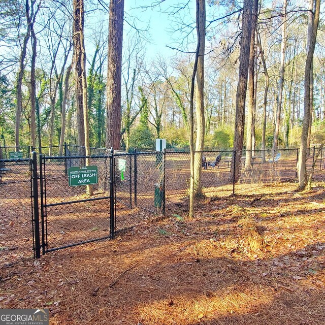 view of property's community featuring a gate and fence