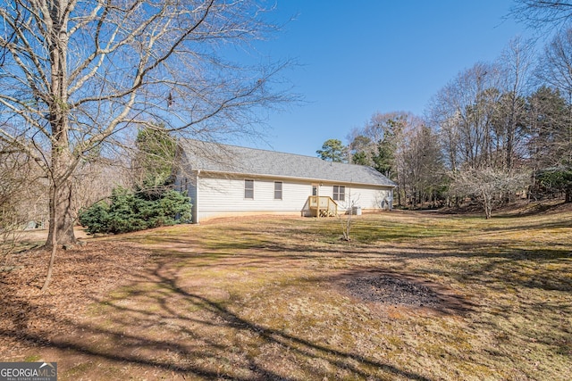 view of side of property with a yard