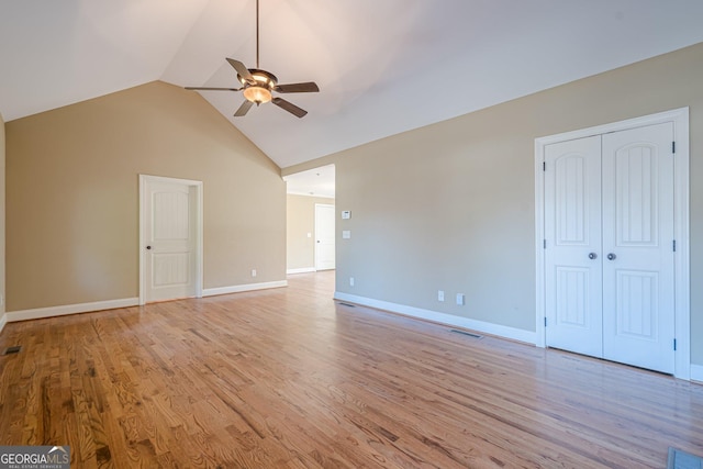 unfurnished living room with visible vents, baseboards, ceiling fan, light wood-style flooring, and high vaulted ceiling