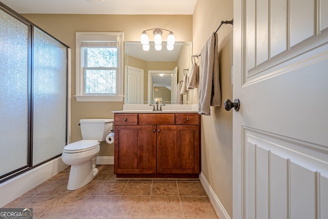 bathroom with vanity, baseboards, tile patterned flooring, toilet, and a shower with door