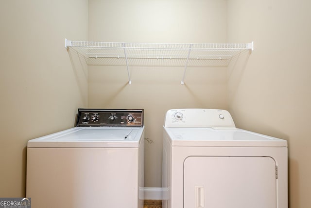 clothes washing area featuring laundry area and washing machine and clothes dryer