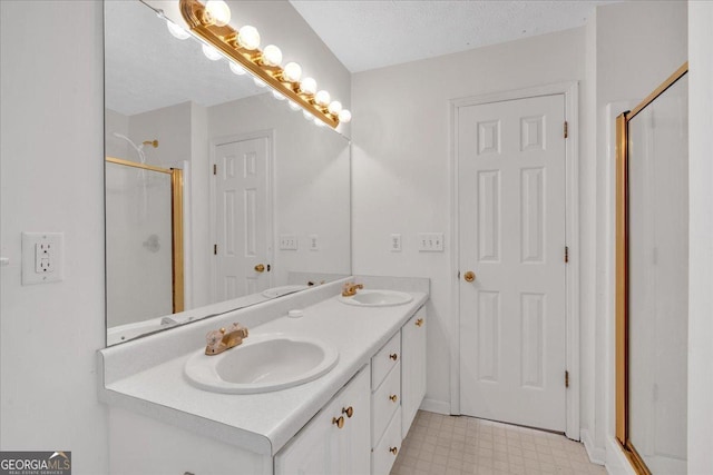 full bathroom with tile patterned floors, a shower stall, double vanity, and a sink